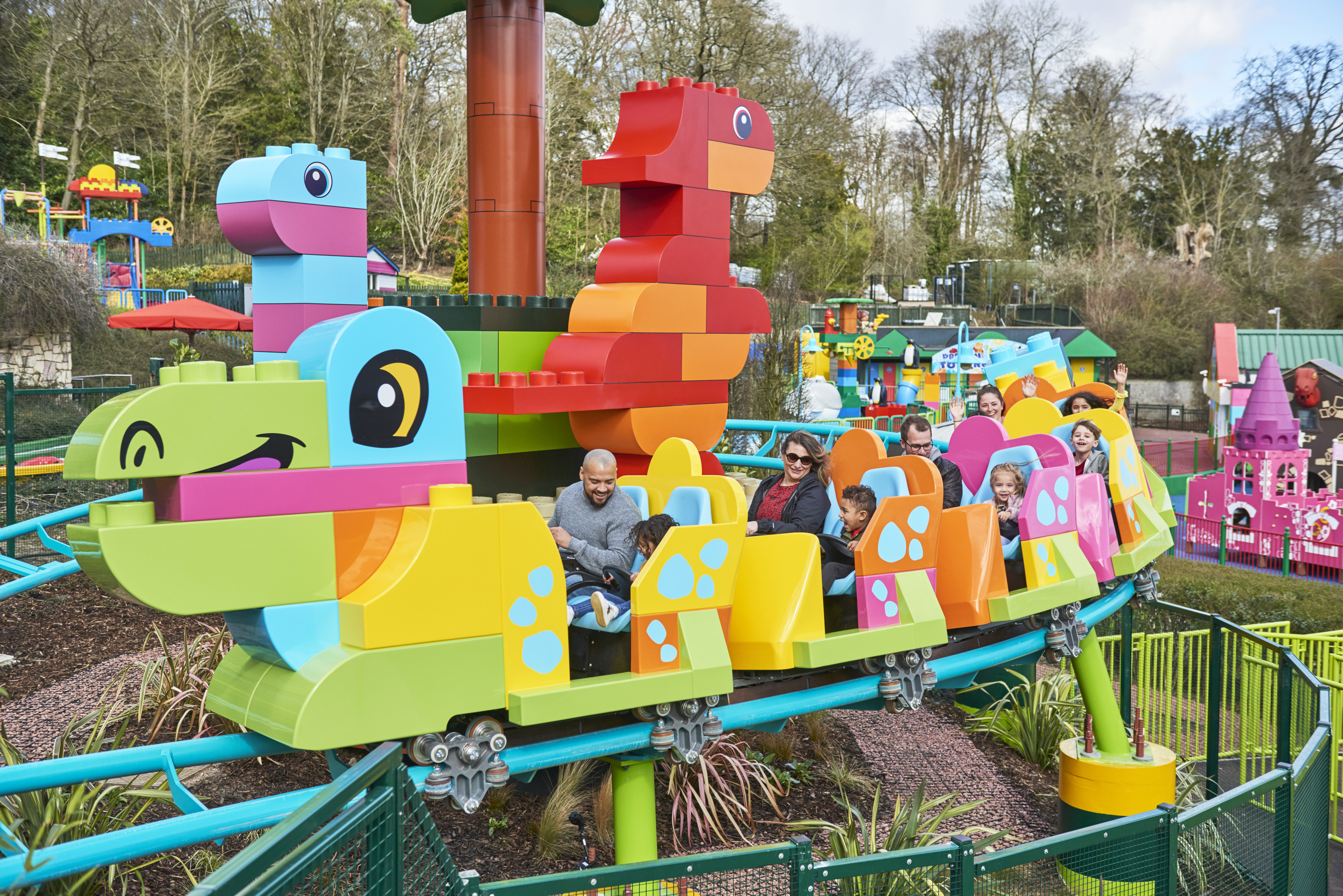 Families riding DUPLO® Dino Coaster at the LEGOLAND® Windsor Resort