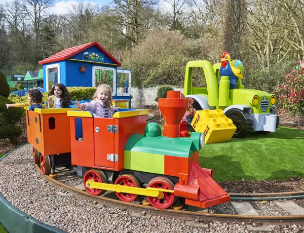 Girls smiling and waving on DUPLO Train