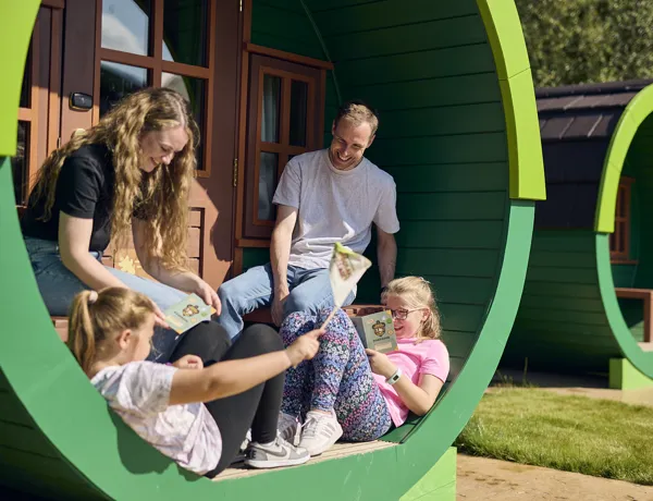 Family sat outside Woodland Village barrel
