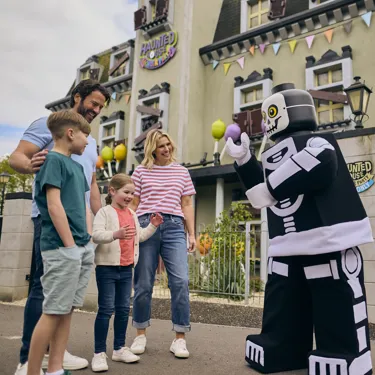 Family meeting Skeleton Guy outside of Haunted House Monster Party
