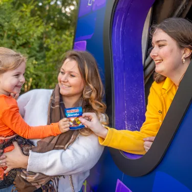 Family At Trick Or Treat Stops