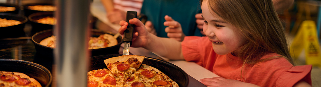 Girl enjoying pizza at City Walk PIzza Pasta