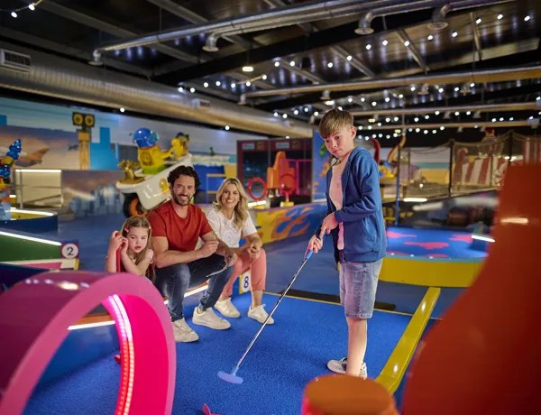 Family Playing LEGO City Course At LEGOLAND Adventure Golf