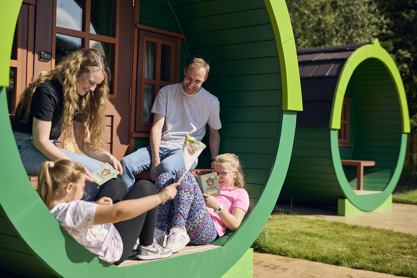 Family sat outside Woodland Village barrel