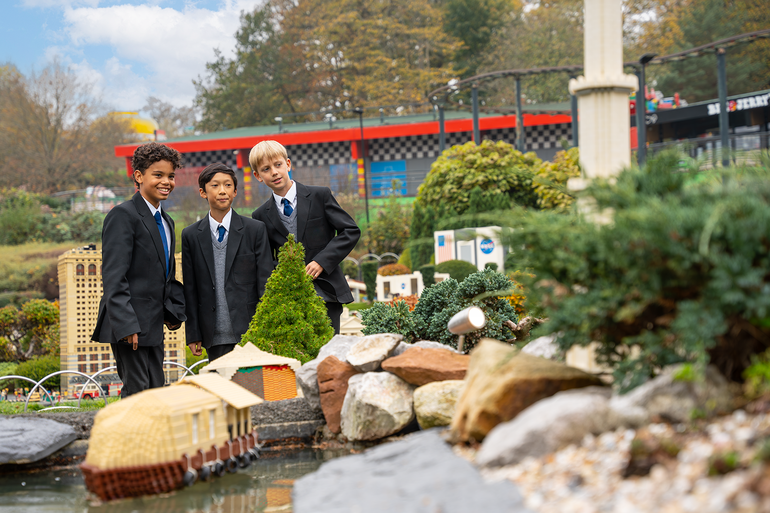 School trip with 3 students in Miniland looking at LEGO models at LEGOLAND Windsor