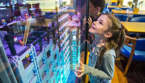 Girl looking at LEGO model in Skyline Bar